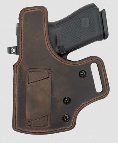 Handgun in brown leather holster
