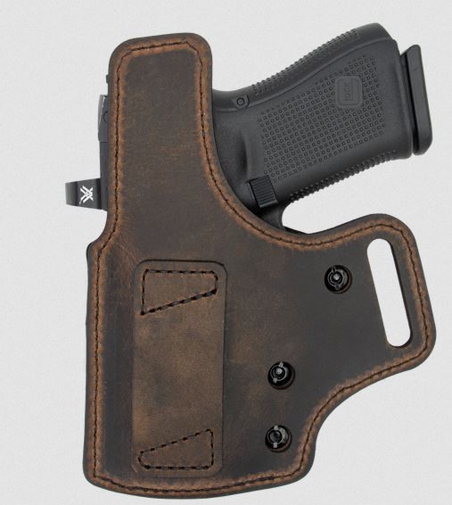 Handgun in brown leather holster