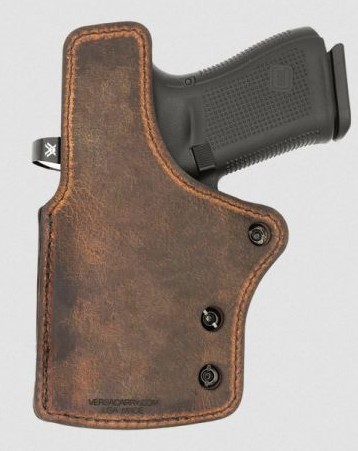 Handgun in brown leather concealed carry holster