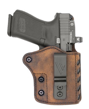 Black pistol in brown leather holster