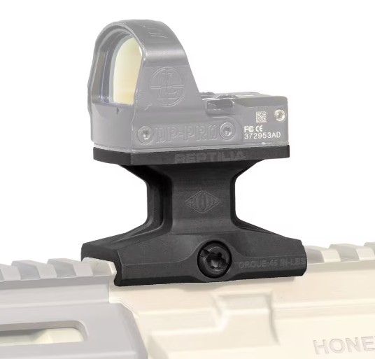 Red dot sight mounted on firearm rail