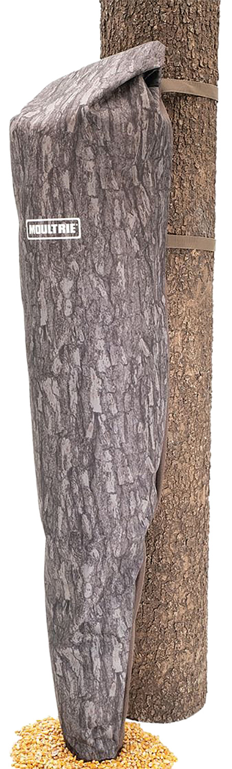 Camouflage deer feeder bag strapped to tree