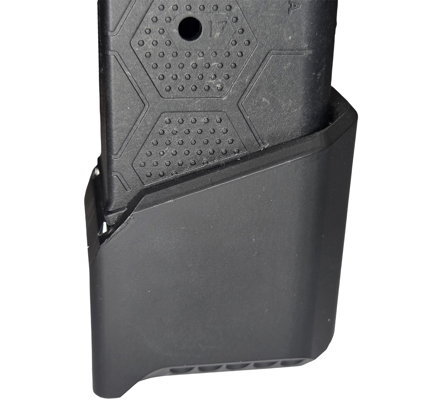Close-up of handgun grip with magazine extension