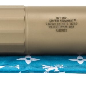 Tan firearm suppressor on blue patterned pouch