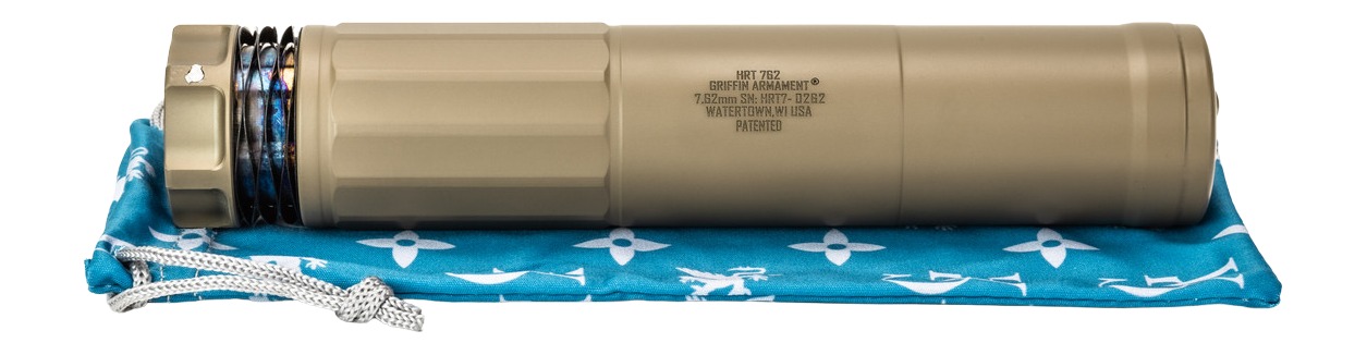 Tan firearm suppressor on blue patterned pouch
