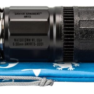 Black firearm suppressor and thread adapter on pouch