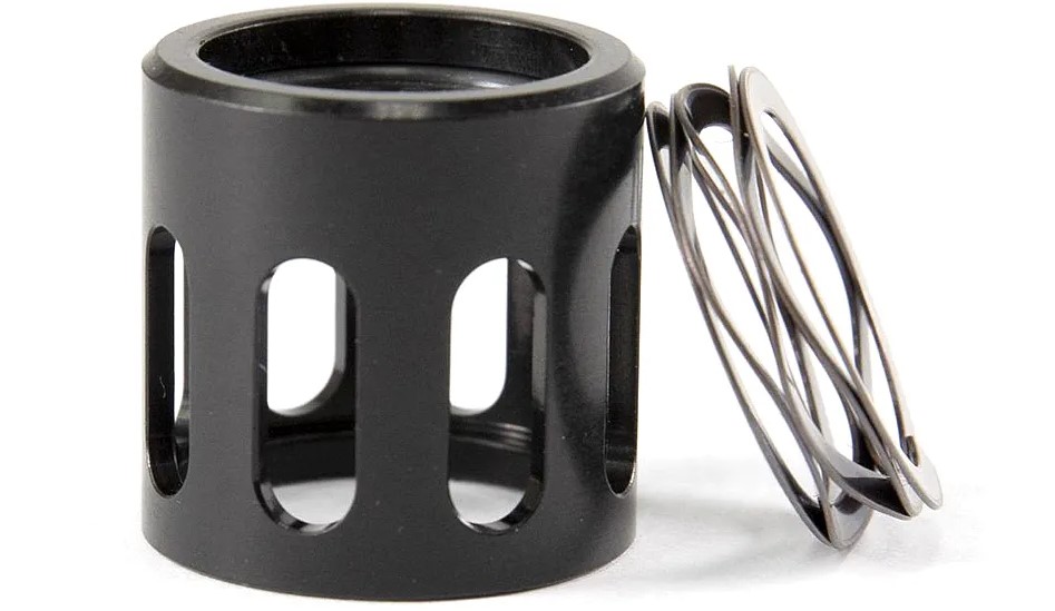 Black cylindrical metal component with coil spring