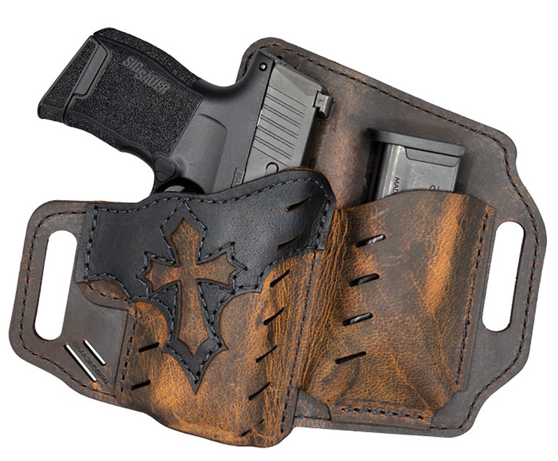 Handgun in brown leather holster with cross design