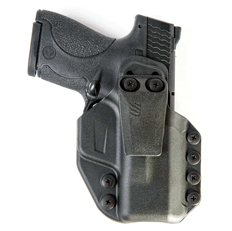Black handgun in molded polymer holster