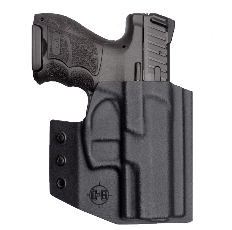 Black handgun in molded holster on white background