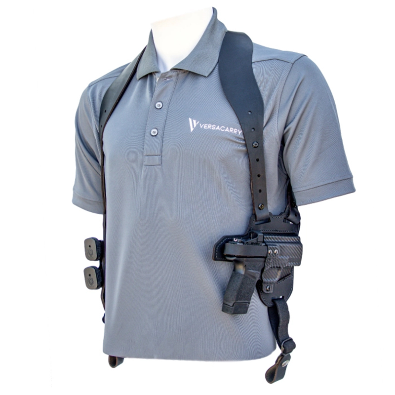Shoulder holster with handgun on gray polo