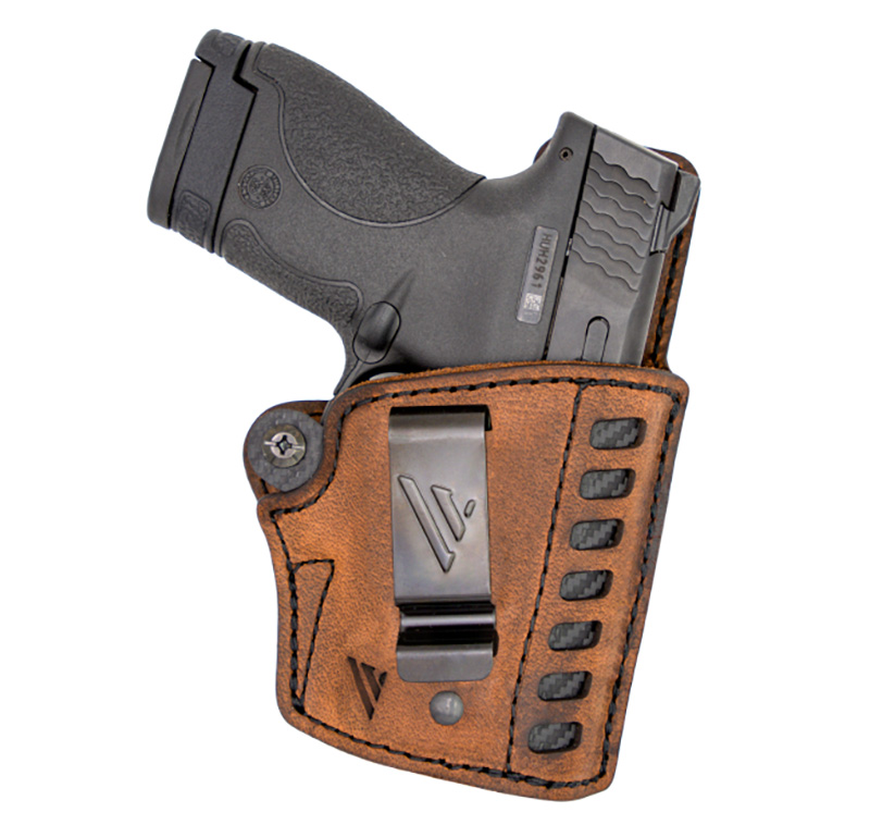 Handgun in brown leather concealed carry holster
