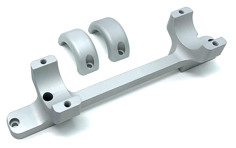 Machined metal bracket with two bearing caps