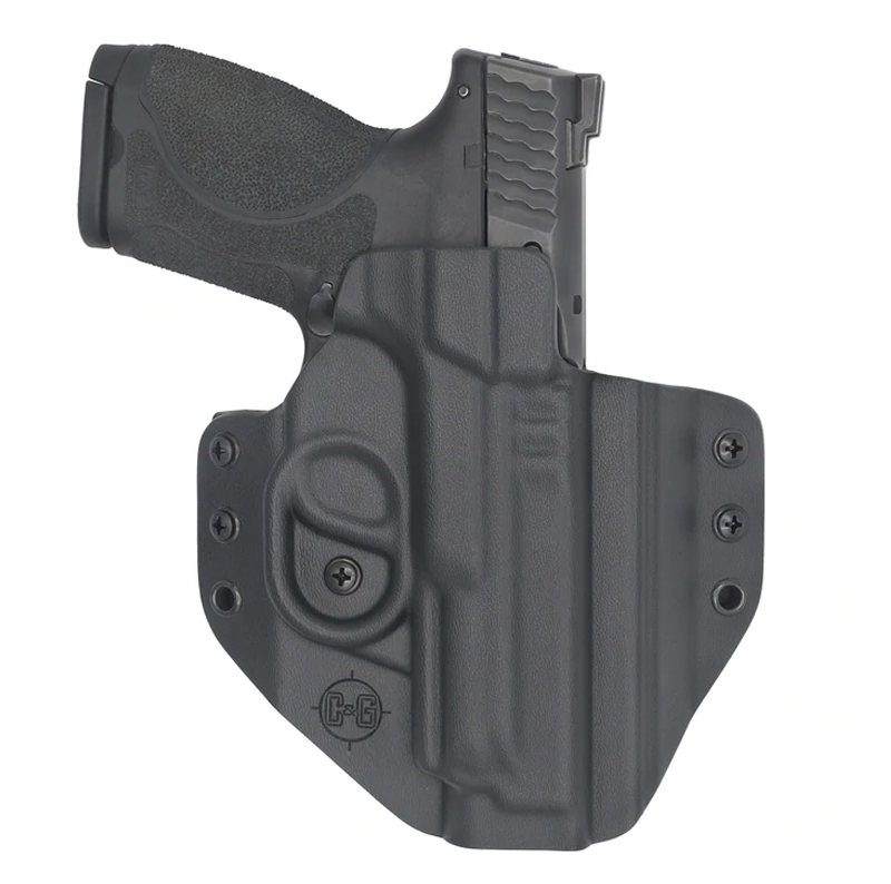 Black handgun in molded polymer holster