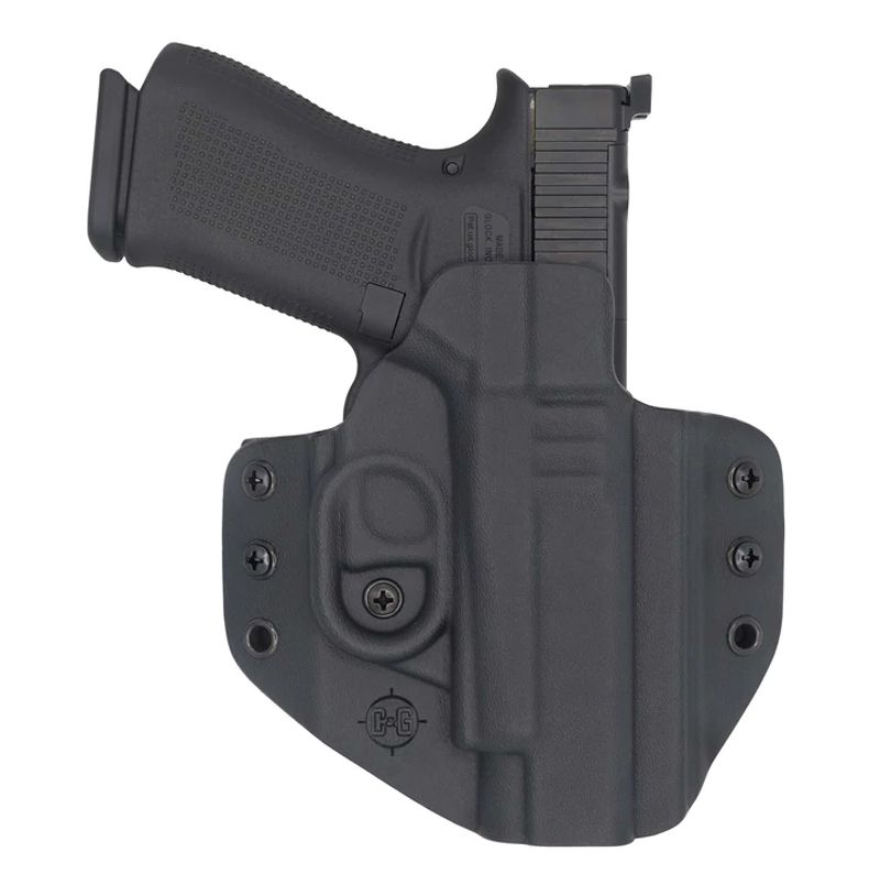 Black pistol in molded Kydex holster