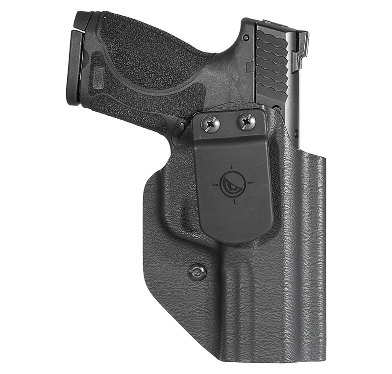 Black handgun secured in molded belt holster