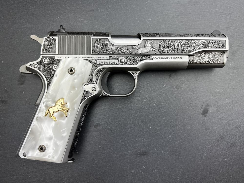 Engraved Colt 1911 pistol with pearl grip