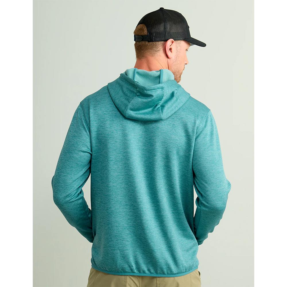 Man wearing teal hoodie and black cap