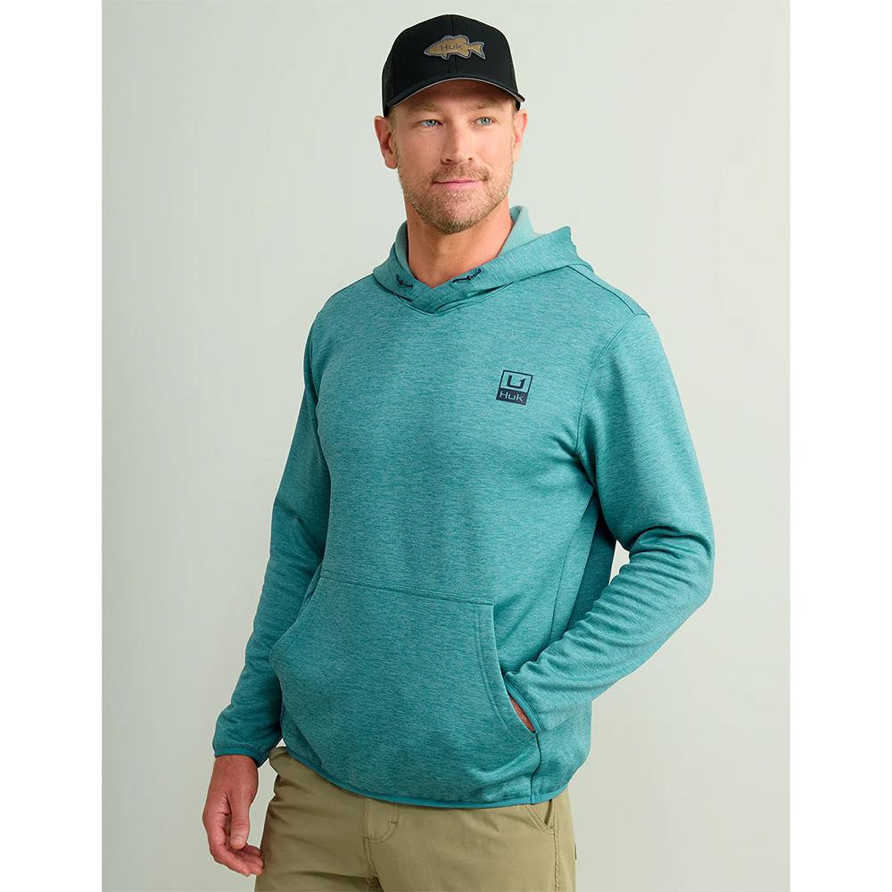 Man wearing teal hoodie and black cap