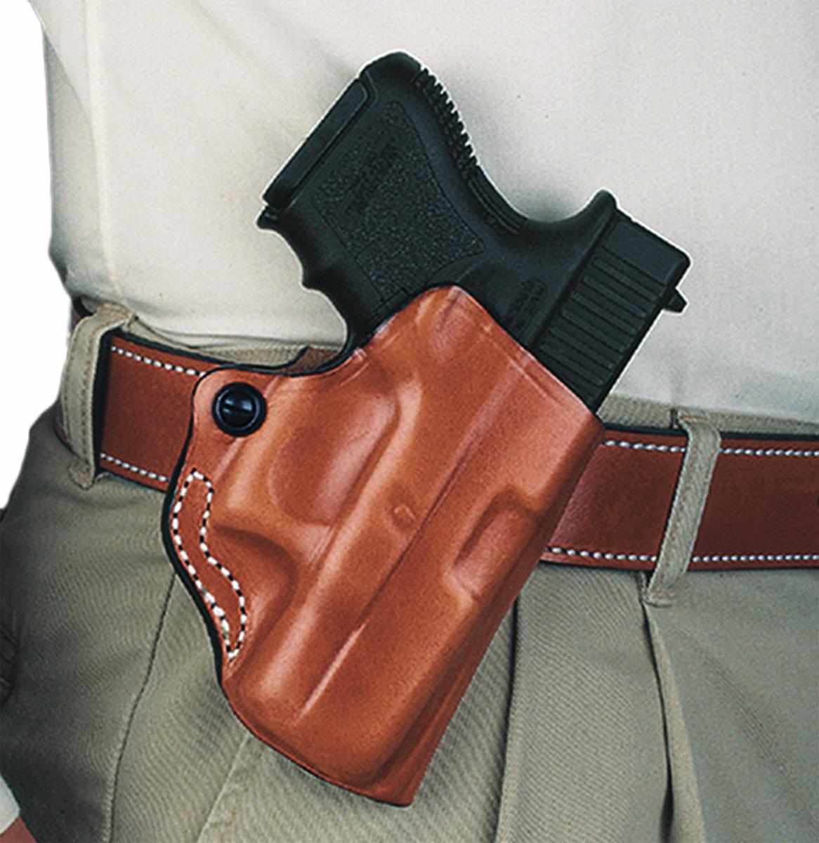 Handgun in brown leather belt holster