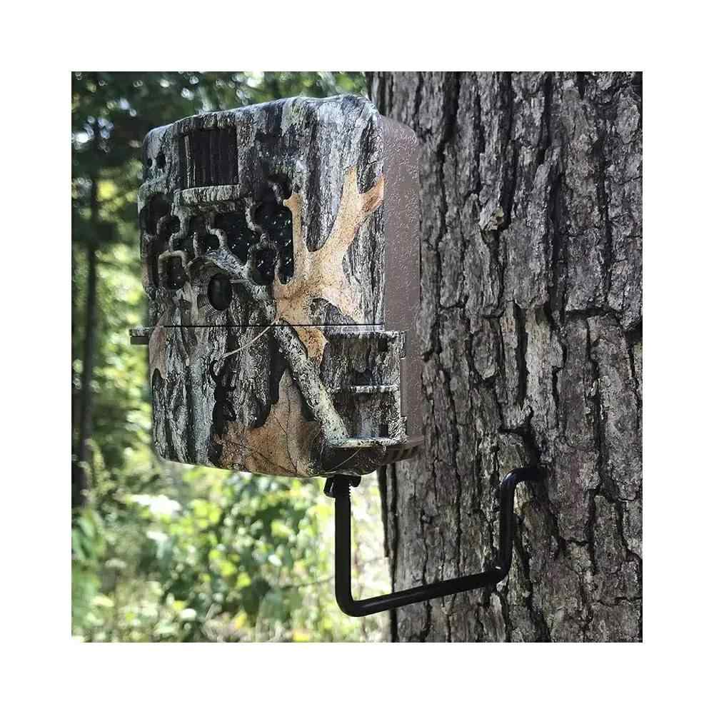 Camouflage trail camera mounted on tree trunk