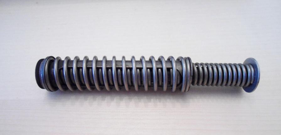Metal compression spring mounted on threaded rod