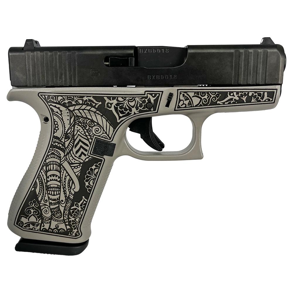 Decorative engraved handgun with elephant design grip