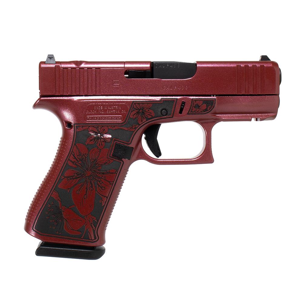 Red floral-engraved semi-automatic handgun on white background