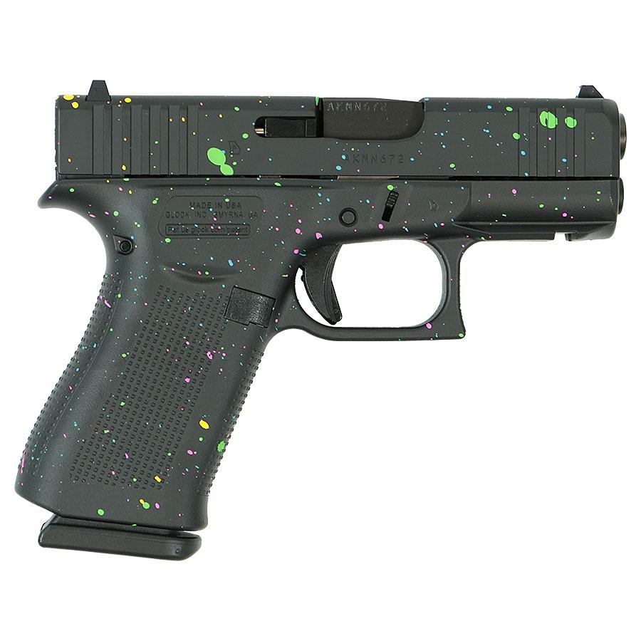 Black handgun with colorful paint splatter design