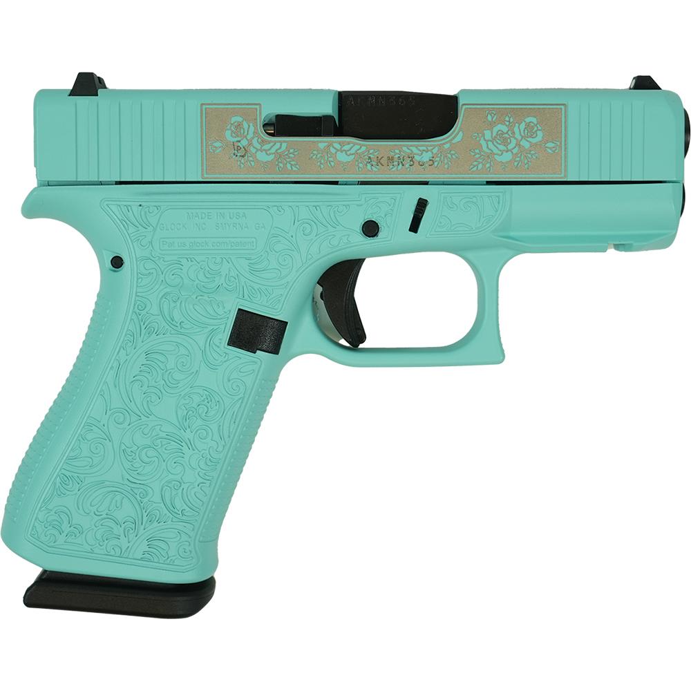 Teal engraved semi-automatic handgun on white background