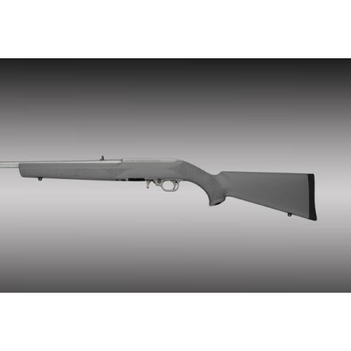 Bolt-action rifle with synthetic stock on gray background