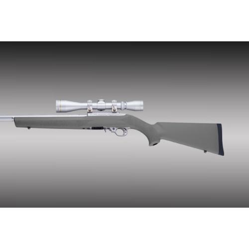 Bolt-action rifle with scope on gray background