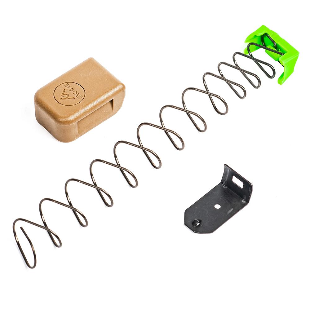 Firearm magazine spring and components on white background