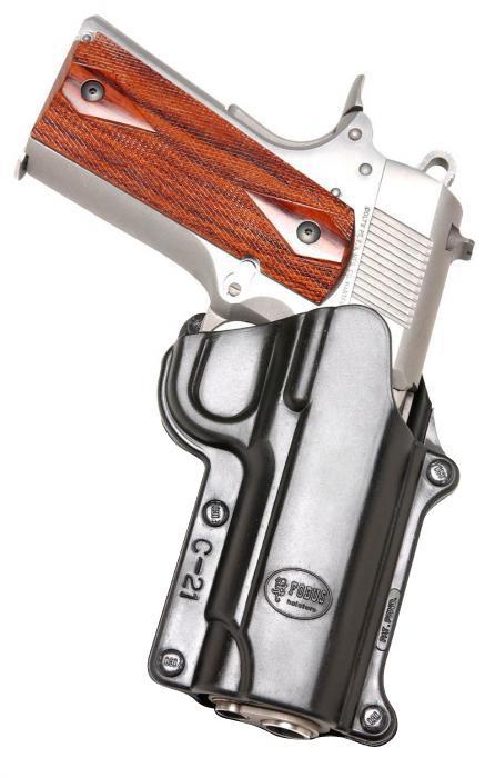 Handgun with wooden grip in black holster