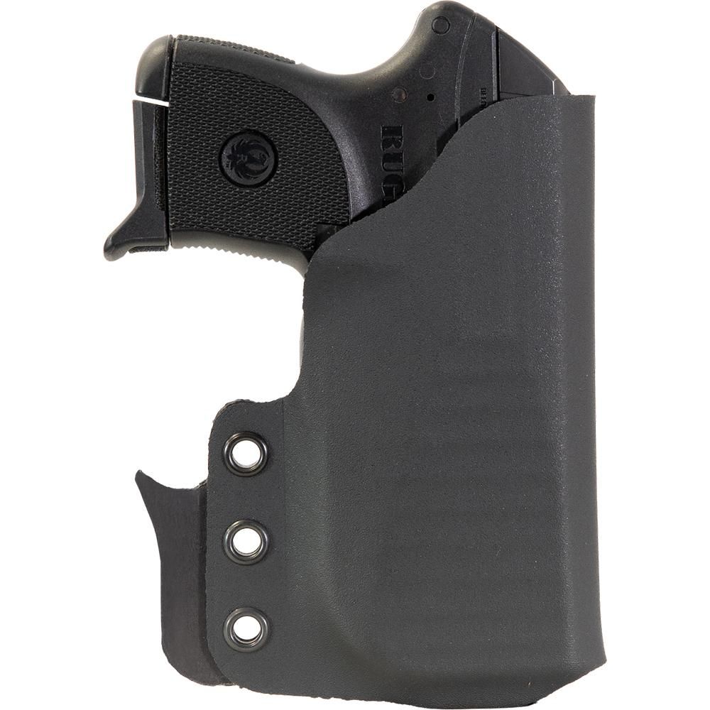 Black handgun in molded concealment holster
