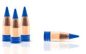 Wooden bullets with blue tips on white background