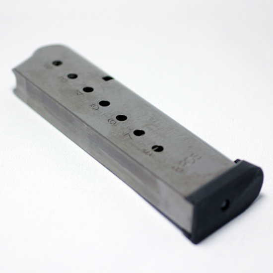 Metal handgun magazine on white background