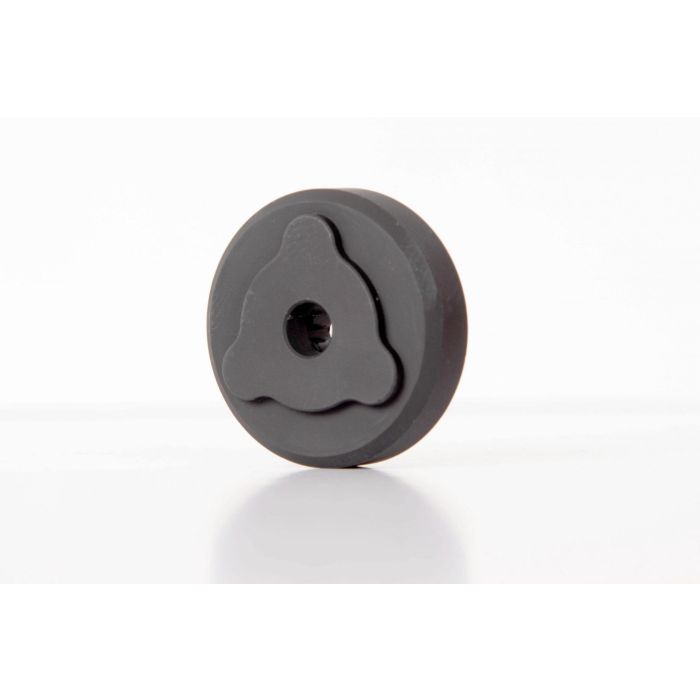 Black circular knob with three-lobed center design