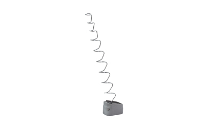 Long coiled metal spring on gray base