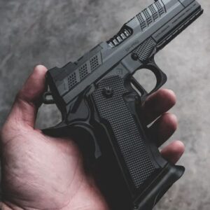 Hand holding a black semi-automatic pistol