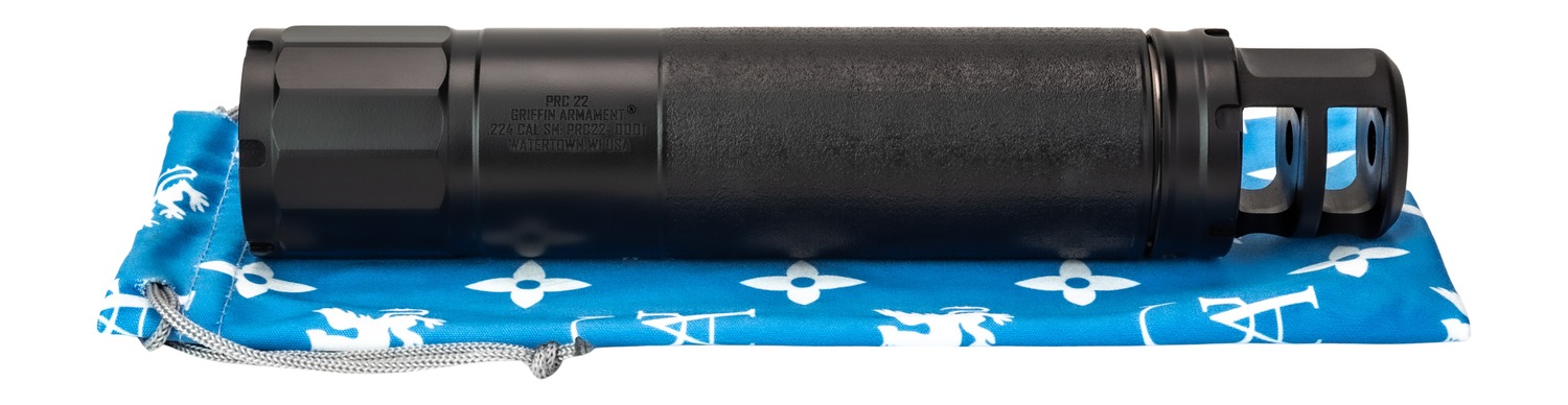 Black rifle suppressor on blue patterned cloth