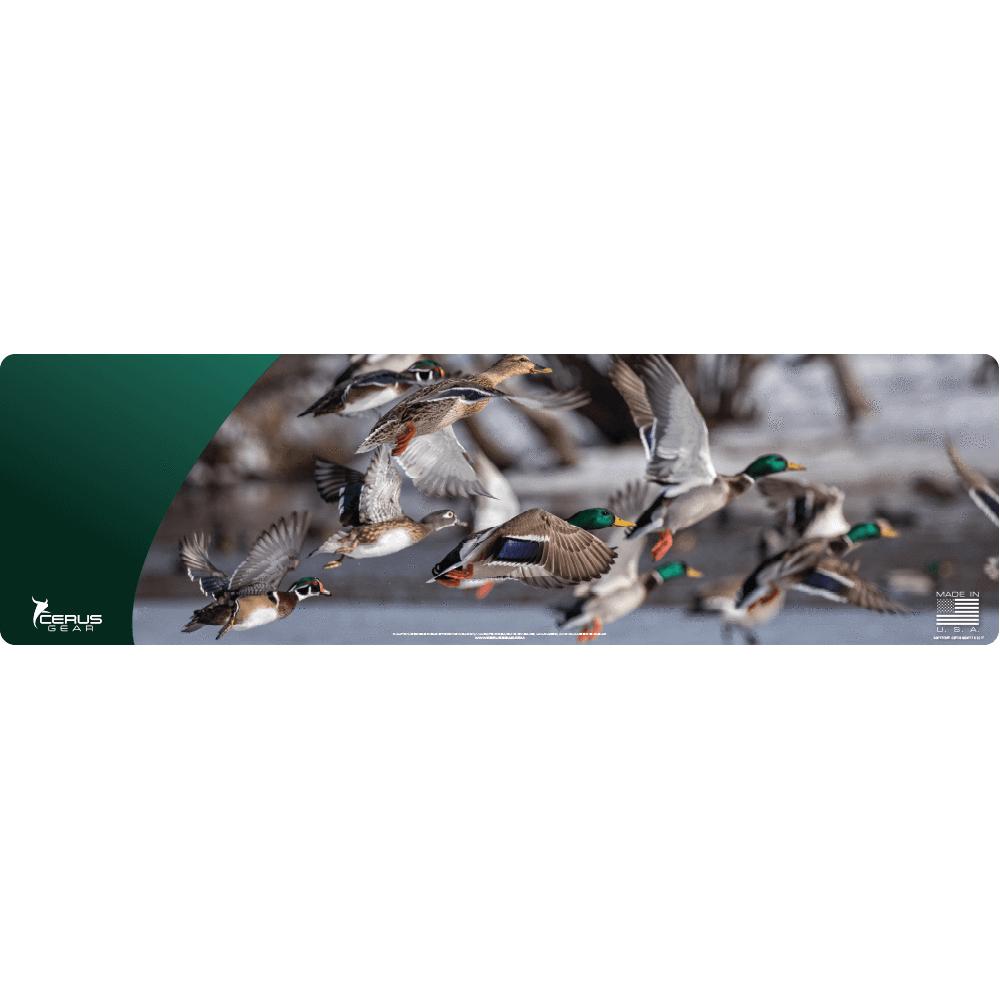 Mallard and wood ducks flying over water