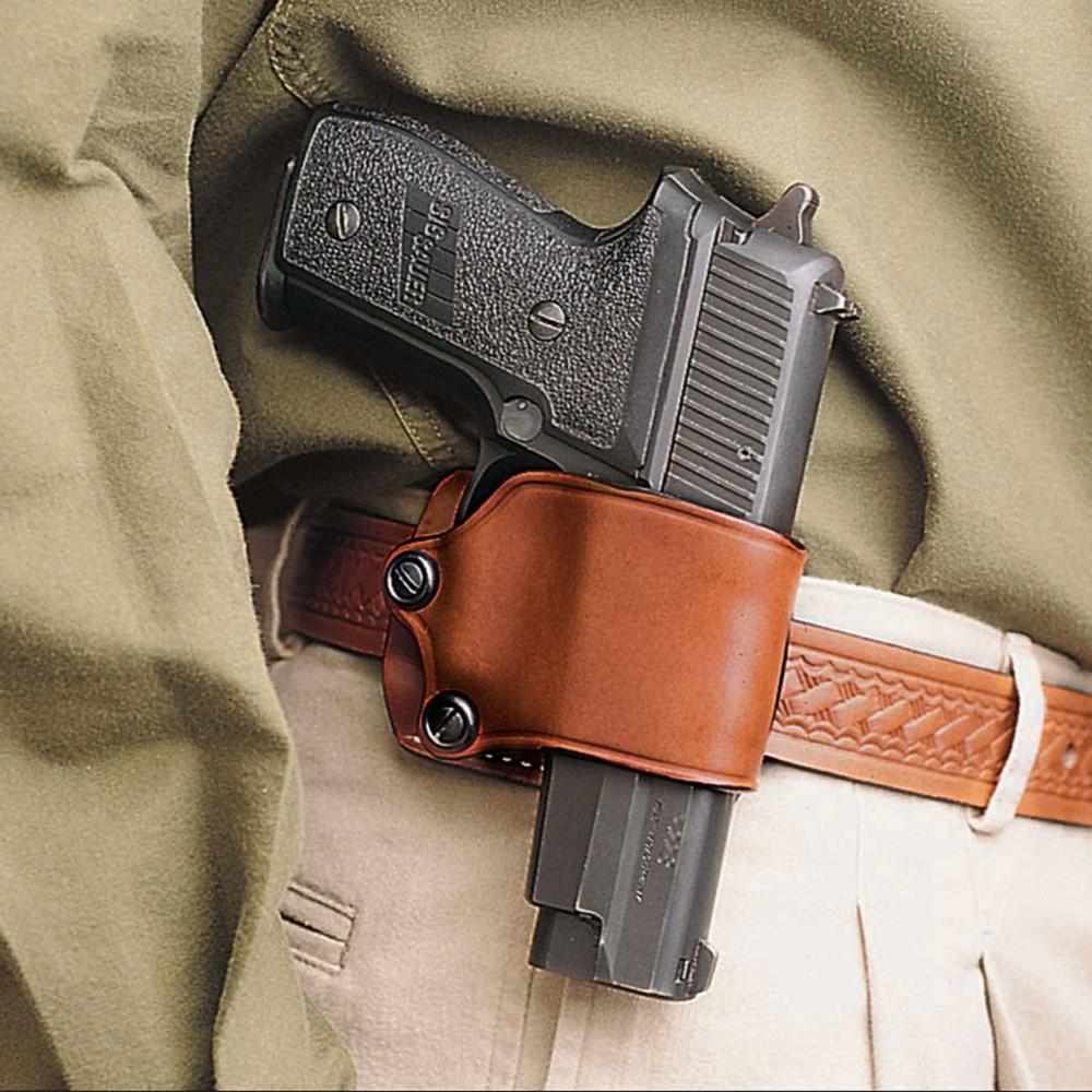 Handgun in brown leather belt holster