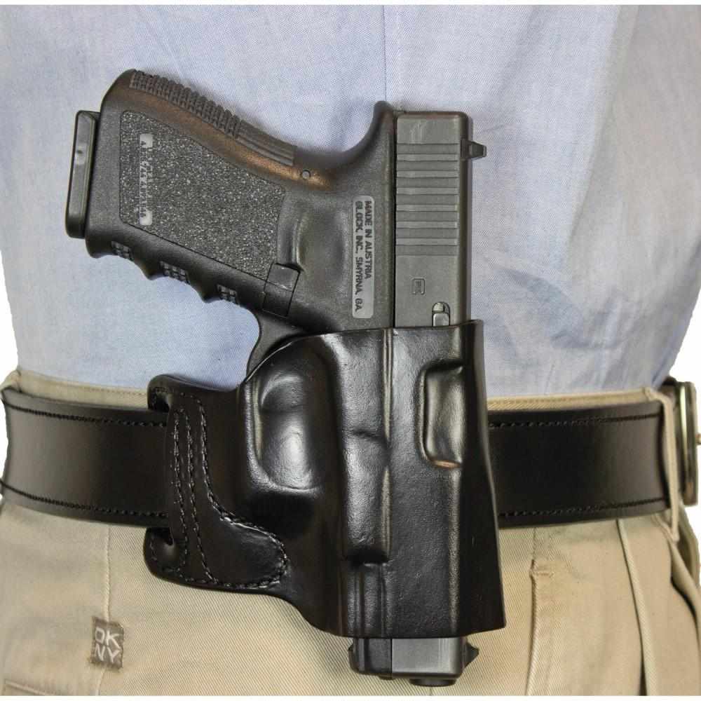 Handgun in black belt holster on waist