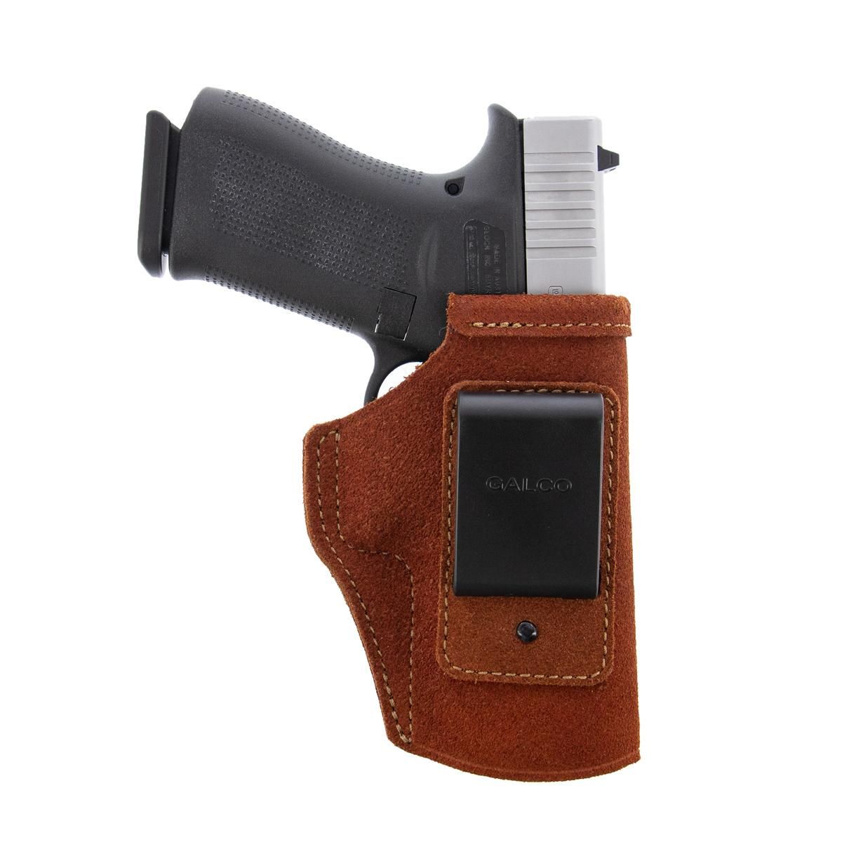 Handgun in brown leather belt holster