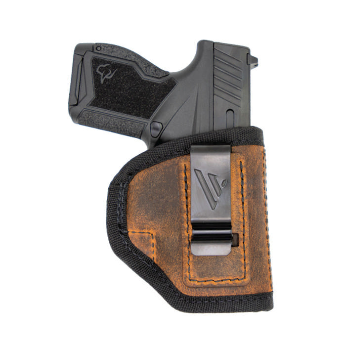 Compact handgun in brown leather holster