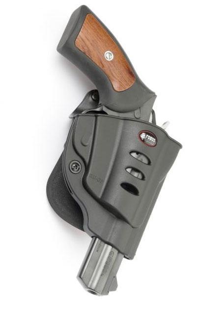 Revolver handgun in black holster with wood grip