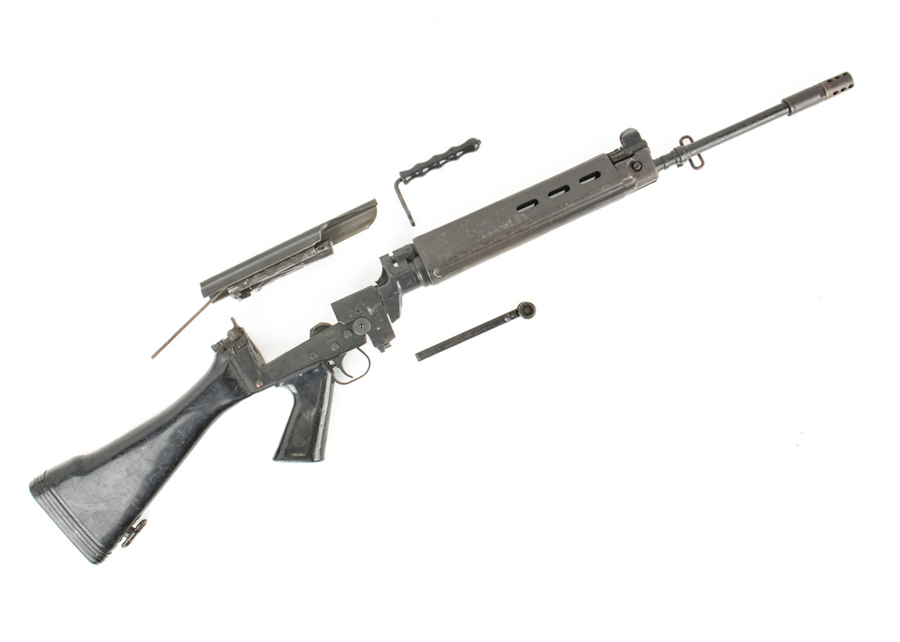 Disassembled rifle with parts on white background