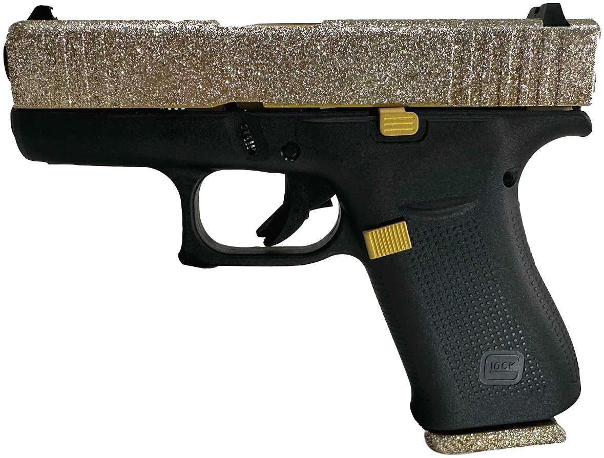 Black handgun with glittery gold slide