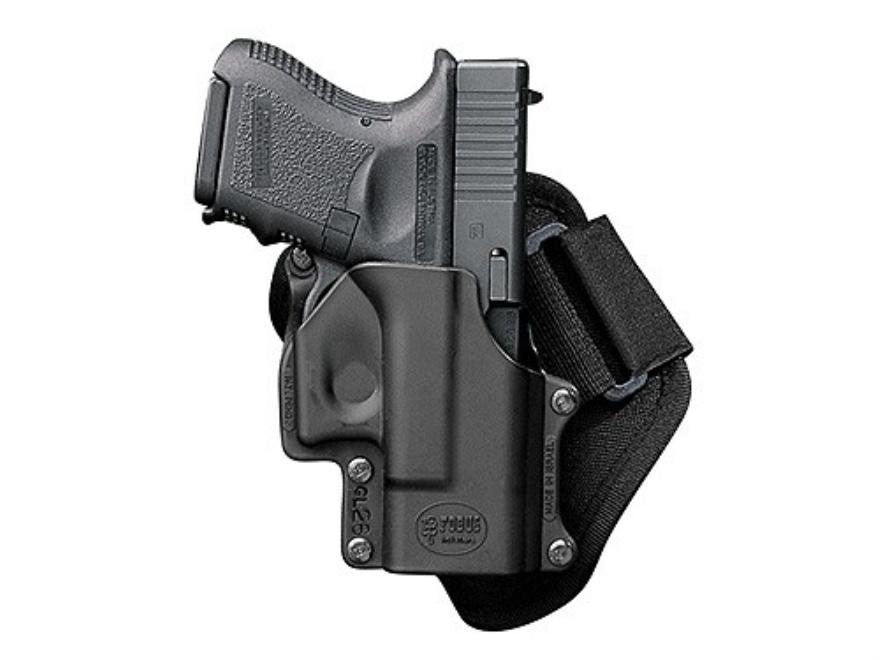 Black handgun in a belt holster